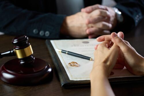 Couple sitting at table with divorce document